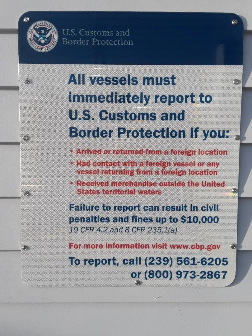 A U.S. Customs and Border Protection sign listing when vessels must report on arrival